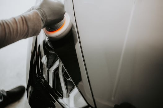 Close up view of a person polishing a black car us
