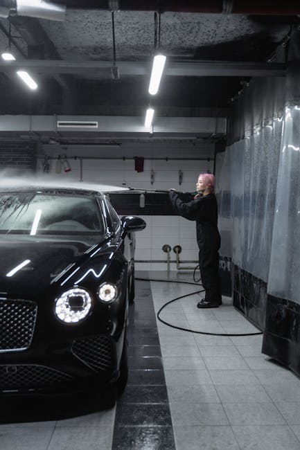 A woman using a pressure washer to clean a luxury
