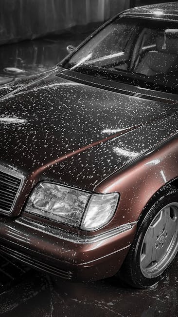 Close up of a brown car covered in water droplets