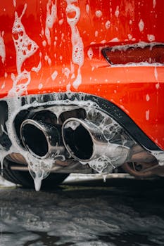 Detailed view of a red sports car exhaust pipe cov