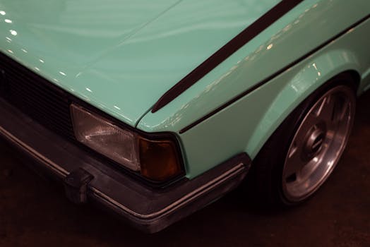 A detailed close up of a vintage cars headlight an