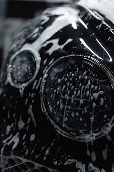 A detailed close up of a car headlight covered wit