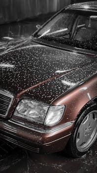 Close up of a brown car covered in water droplets