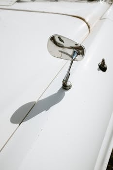 Detailed view of a chrome side mirror on a vintage
