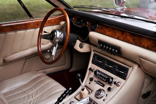 Close up of a vintage car interior featuring woode
