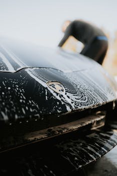 Close up of a luxury sports car under soap suds du